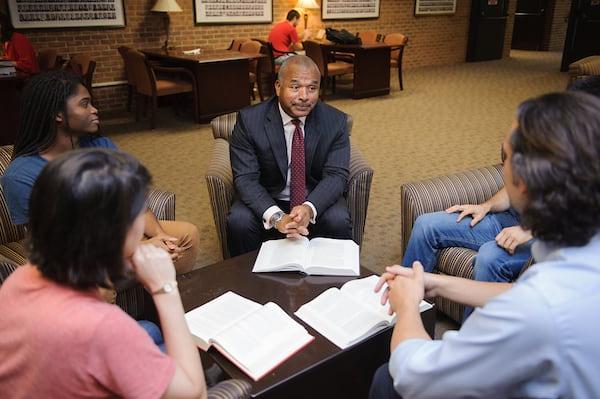 Law students discuss course material with a faculty member